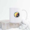 Sleek white 11oz ceramic mug featuring the colorful Facel Vega emblem, on a kitchen counter backdrop.