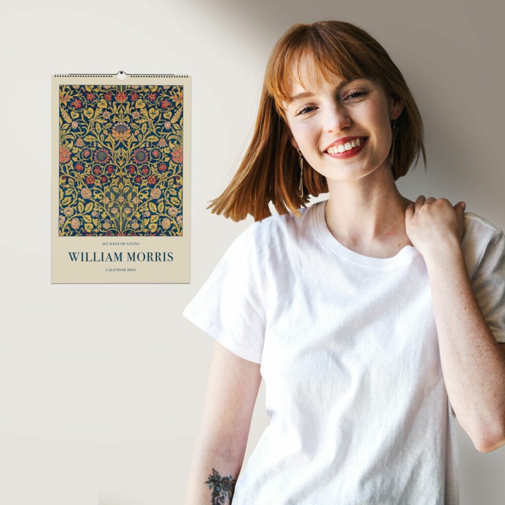 2024 William Morris wall calendar with intricate floral pattern design in rich hues of red, blue, and gold, titled '365 Days of Giving'