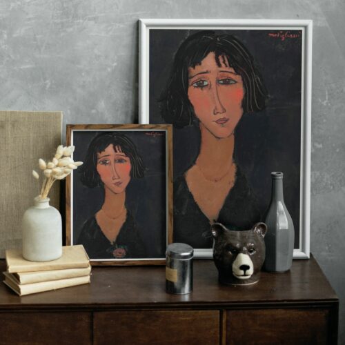 A melancholic portrait by Amedeo Modigliani, featuring a woman with dark hair and sad, expressive eyes. Her pale face is accentuated with subtle blush tones, and she wears a dark V-neck garment with a decorative floral pin. The intense gaze and Modigliani's signature elongated neck and simplified features evoke a deep emotional response.