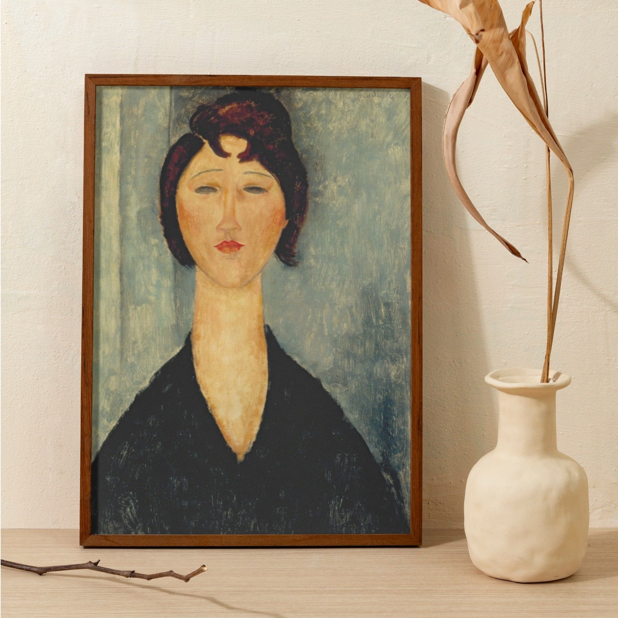 Modigliani's 'Tête de jeune fille', a portrait of a young woman with subdued expression, her dark hair contrasting with her pale skin and a deep black garment. The subject's serene demeanor and Modigliani's distinct style of elongated neck and face are highlighted against a soft, textured background.