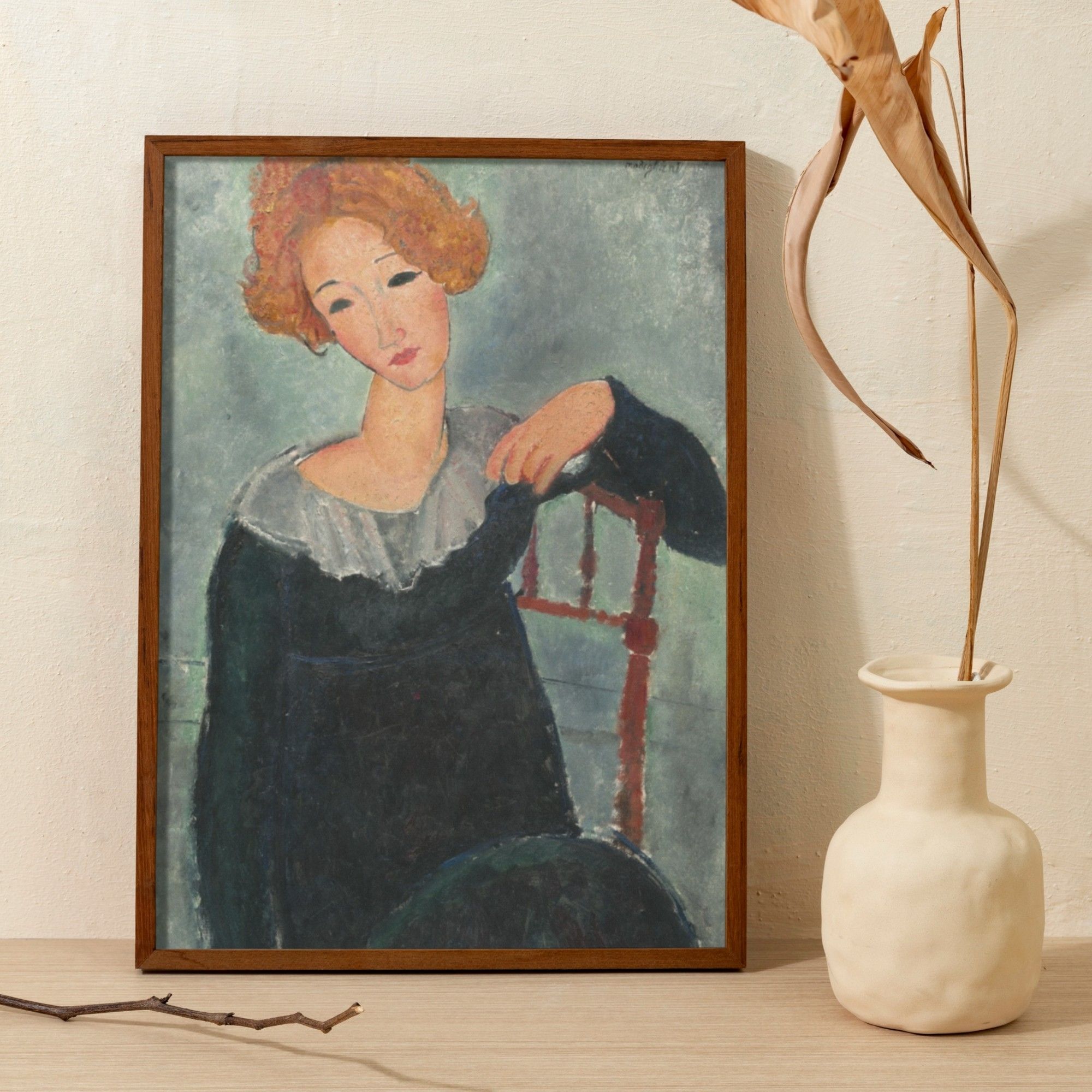 Portrait of a woman with red hair by Amedeo Modigliani, showcasing the artist's signature style of elongated features and serene expression. The subject's auburn hair complements her pensive gaze, as she rests her chin on her hand. This early 20th-century masterpiece combines elements of modernism with a touch of classical grace.