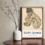 Egon Schiele 1914 Poster - 'Crouching Nude Girl' Artwork with Dynamic Pose and Earthy Watercolor Tones, Highlighting Schiele's Signature Drawing Style