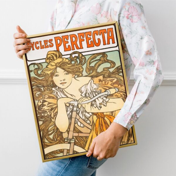 Mucha's Cycles Perfecta poster with a windswept woman riding, highlighting dynamic motion and Art Nouveau flair.