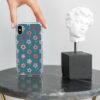 Vibrant teal phone case with a colorful floral pattern, offering a fresh and fashionable look for smartphone protection on a textured grey background