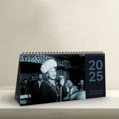 Desk calendar with a vintage black-and-white photo of Ella Fitzgerald, radiating joy as she performs, microphone in hand, with an enthusiastic audience in the background. The cover denotes the 'Golden Age of Jazz.'