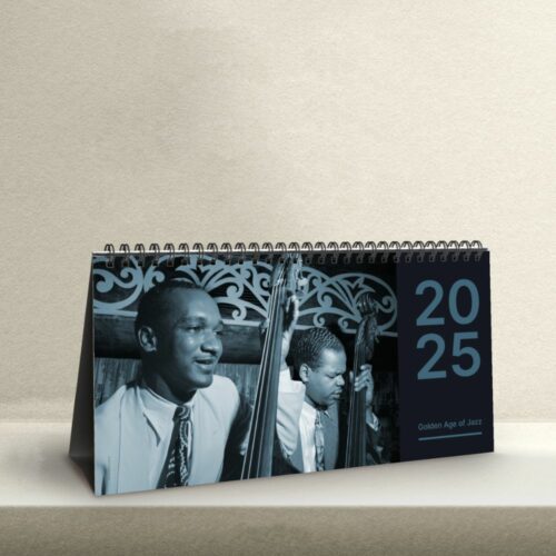 Desk calendar featuring a black-and-white photo of Oscar Pettiford, the influential jazz double bassist, playing his instrument with intensity, under the 'Golden Age of Jazz' title.