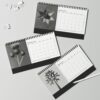 Karl Blossfeldt Desk Calendar featuring high-contrast black and white botanical photography prints, spiral-bound and displayed on a textured background for home or office decor.