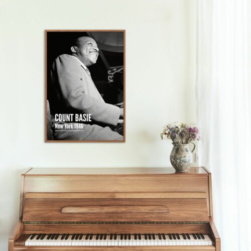 Vintage black and white poster of legendary jazz musician Count Basie playing piano, smiling in New York, 1946, iconic for swing music enthusiasts and historical music memorabilia collectors.