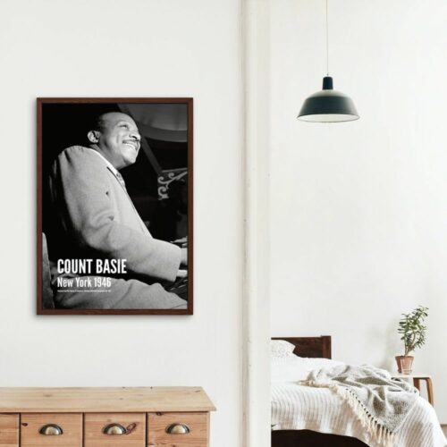 Vintage black and white poster of legendary jazz musician Count Basie playing piano, smiling in New York, 1946, iconic for swing music enthusiasts and historical music memorabilia collectors.