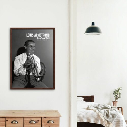 Black and white photo of Louis Armstrong smiling with trumpet, titled LOUIS ARMSTRONG New York 1946, in white shirt and tie, expressing joy and the spirit of jazz.