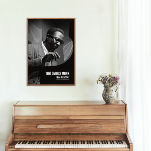Black and white photo of Thelonious Monk in glasses and striped suit playing piano, titled THELONIOUS MONK New York 1947, capturing a focused performance and jazz elegance.