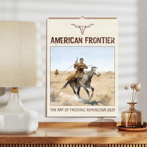 A displayed wall calendar with a cowboy riding through the desert, indicative of American frontier art.