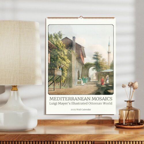 Wall calendar displayed on a wooden stand, titled 'Mediterranean Mosaics,' showcasing Luigi Mayer's illustrated Ottoman scenes for 2025, with a serene streetscape.