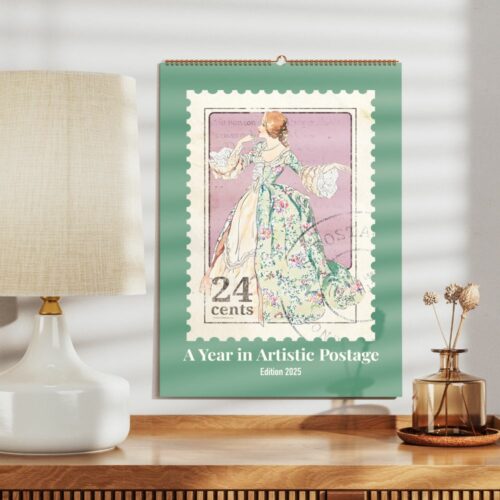 Calendar for A Year in Artistic Postage Edition 2025 featuring a vintage dress stamp design on a desk beside a lamp and vase