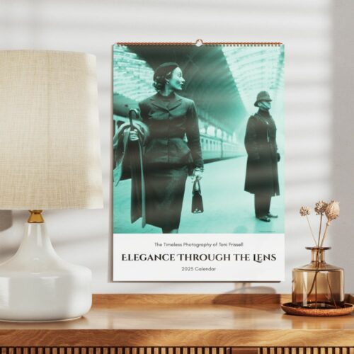 Elegance Through the Lens 2025 Calendar featuring a black and white photo of a poised woman in vintage fashion attire standing at a sunlit concave structure, perfect for art lovers and history enthusiasts