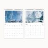 July and August 2025 calendar pages with striking images of a sailing ship amidst ice formations and arctic terrain.