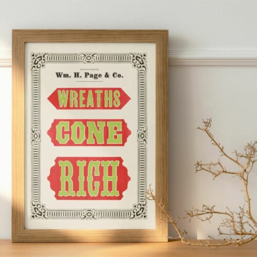 A framed image on a wall with a vintage typographic design featuring the text "Wreaths Cone Rich" in bold green and red letters against a beige background, surrounded by ornate dark gray embellishments. The bottom reads "Wm. H. Page & Co." suggestive of an old-fashioned advertisement or decorative print, placed against a blue wall above a wooden floor.