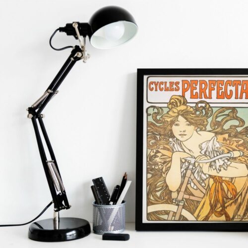 Mucha's Cycles Perfecta poster with a windswept woman riding, highlighting dynamic motion and Art Nouveau flair.
