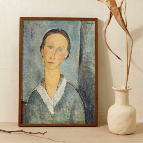 Elegant portrait by Amedeo Modigliani titled 'Jeune fille en blouse', depicting a young lady with a serene expression, wearing a collared blouse. Her graceful posture and the soft, dreamy background are characteristic of Modigliani's style, emphasizing the elongated neck and the simplicity of the facial features.