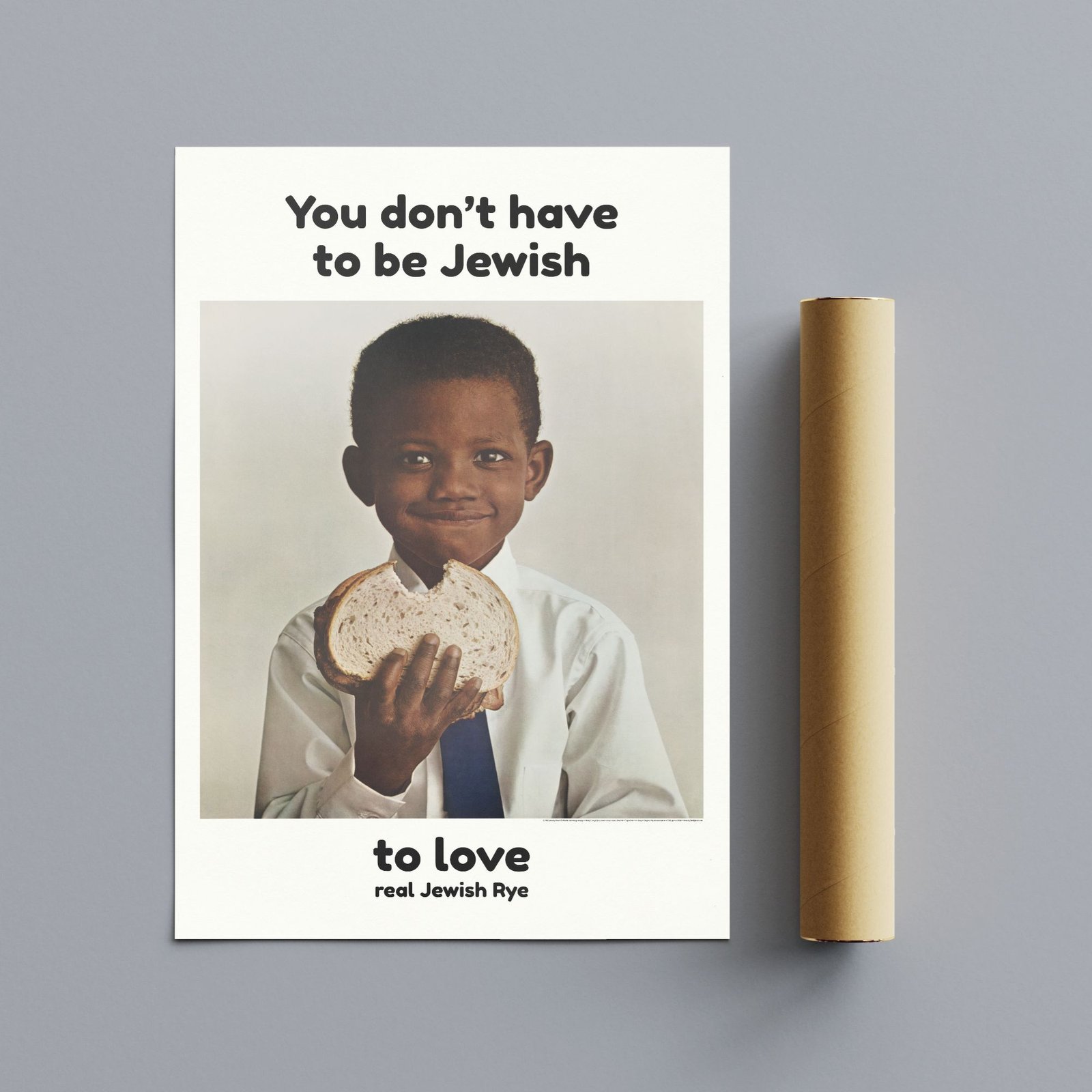 Child holding rye bread slice smiling.