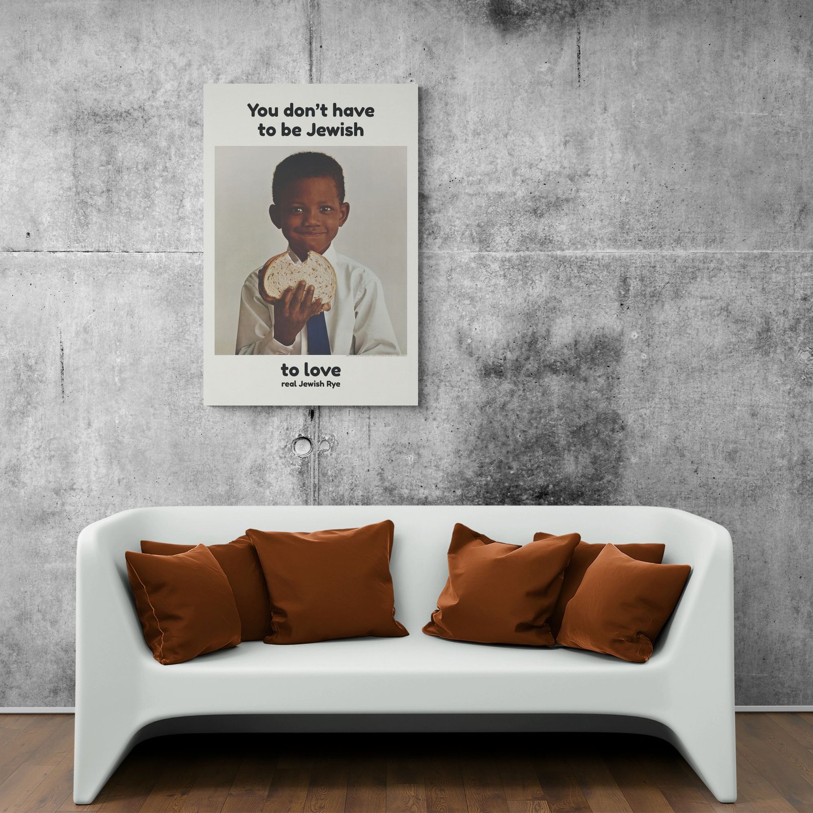 Poster above couch in modern concrete room.