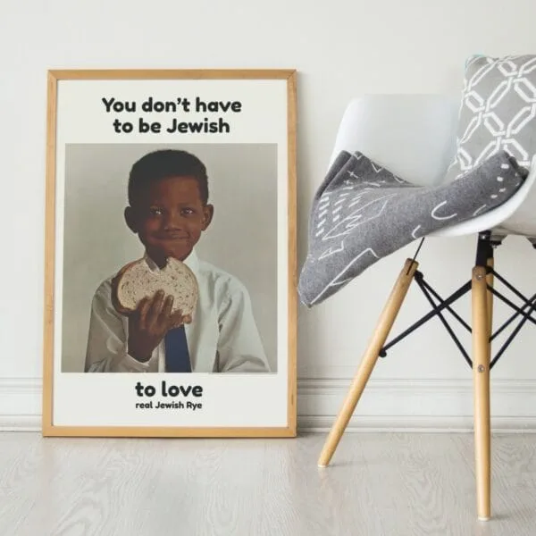 You Dont Have to Be Jewish vintage poster featuring a smiling Black boy holding a slice of rye bread. Iconic 1960s ad campaign promoting Levys Jewish Rye with inclusive messaging. Retro typography, cultural impact, and mid-century advertising design.