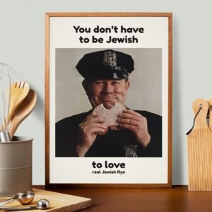 Smiling officer eating a sandwich, framed photo.