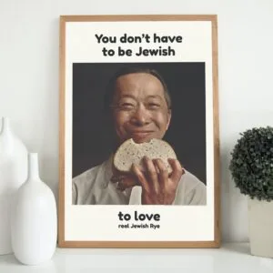 "You Don’t Have to Be Jewish" vintage poster featuring a smiling Asian man holding a slice of rye bread. Iconic 1960s Levy’s Jewish Rye ad campaign with inclusive messaging. Retro typography, cultural impact, and mid-century advertising design.