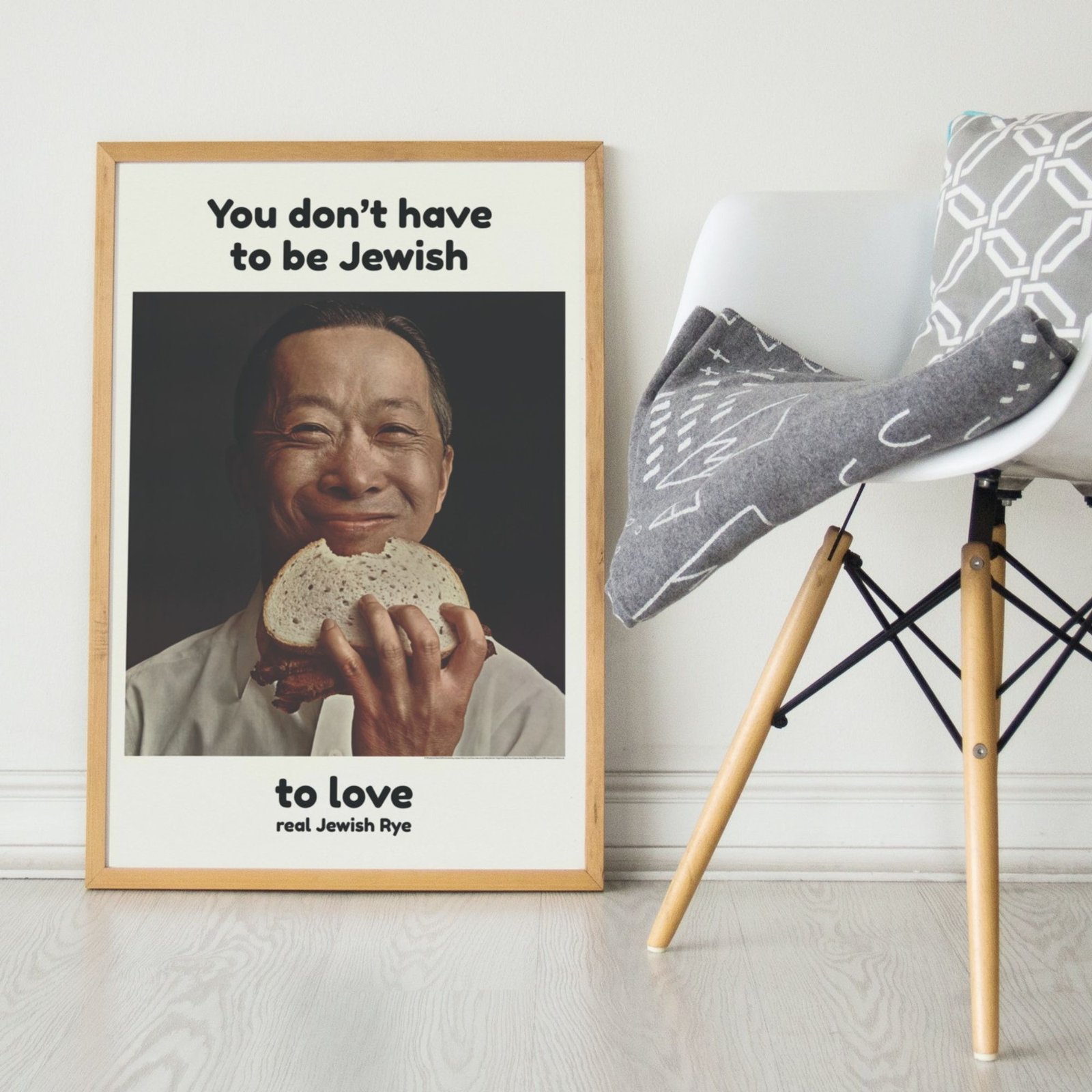 Poster of smiling person with bread sandwich.