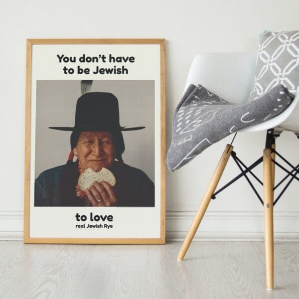 Vintage advertisement poster featuring a smiling Native American man with long braids and a feathered hat, holding a sandwich on Jewish rye bread. A nostalgic piece of 1960s advertising history.