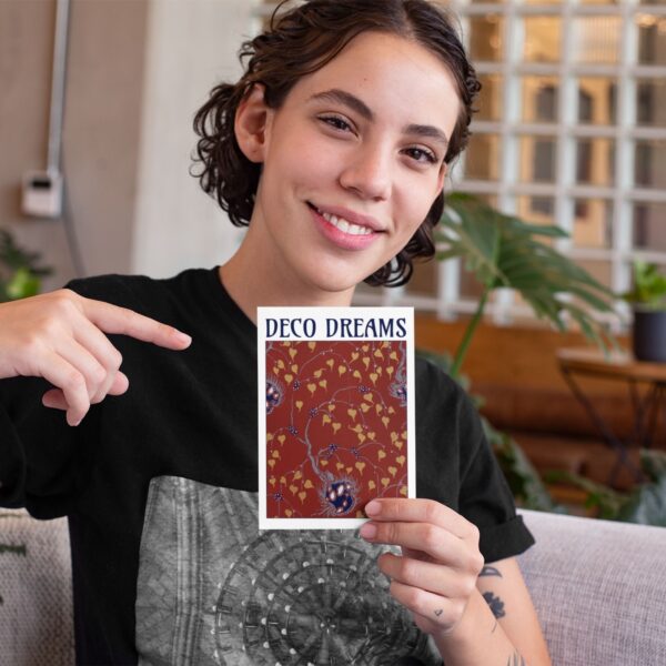 Person holding Deco Dreams book with floral cover.