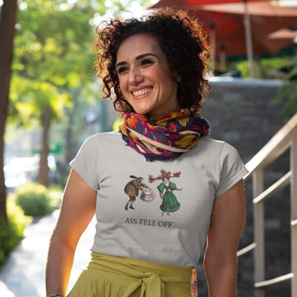 Smiling woman wearing humorous graphic t-shirt outdoors.