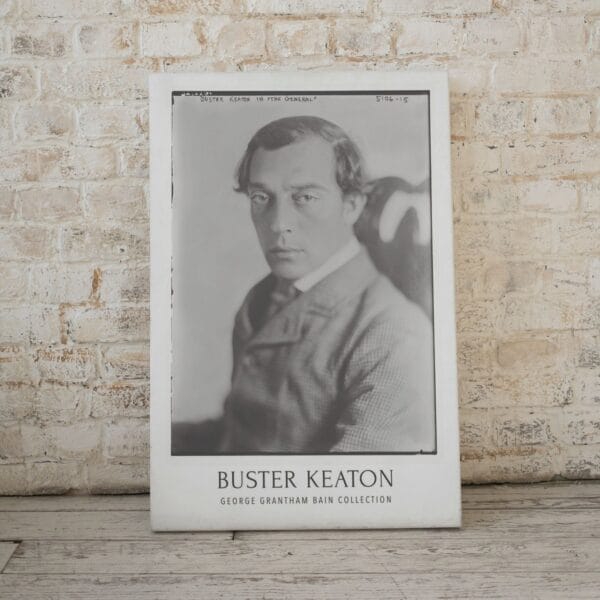 Buster Keaton vintage movie poster featuring a classic black-and-white portrait from the silent film era. Perfect for retro movie decor, classic Hollywood wall art, and film buff collections. A must-have for silent film lovers and vintage cinema enthusiasts.