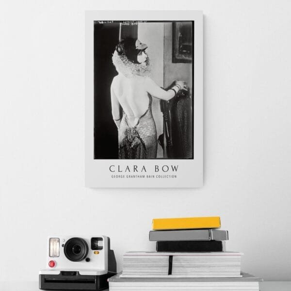 Vintage black and white Clara Bow movie poster featuring the 1920s silent film star in an elegant backless gown. A timeless tribute to Hollywood’s iconic ‘It Girl,’ perfect for classic film enthusiasts and vintage decor lovers.