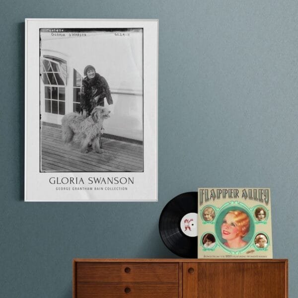 Vintage black-and-white Gloria Swanson poster featuring the Hollywood silent film star with a fluffy dog on a ship deck. Classic cinema-inspired wall art, available as a premium museum-quality print or foam board for retro decor lovers and old Hollywood enthusiasts.