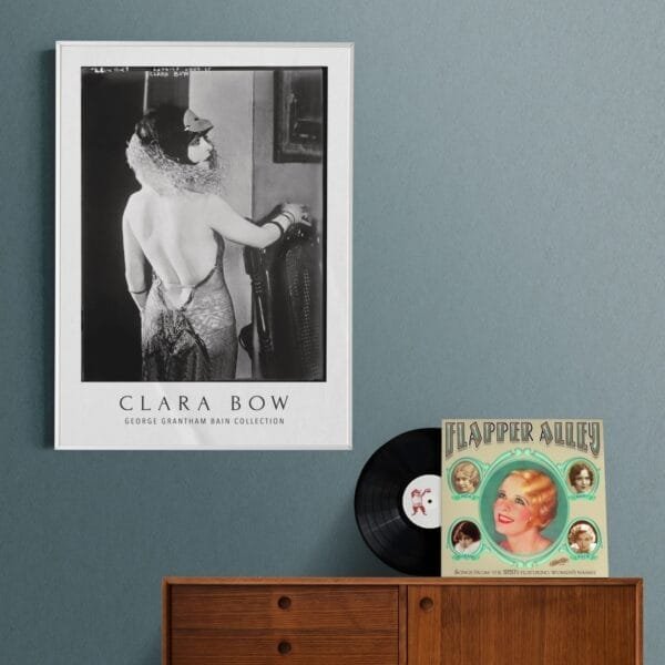Vintage black and white Clara Bow movie poster featuring the 1920s silent film star in an elegant backless gown. A timeless tribute to Hollywood’s iconic ‘It Girl,’ perfect for classic film enthusiasts and vintage decor lovers.