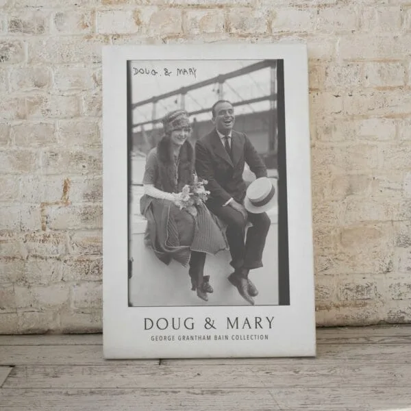 Black and white vintage movie poster featuring silent film stars Mary Pickford and Douglas Fairbanks, part of the George Grantham Bain Collection. Classic Hollywood decor for film enthusiasts and vintage art collectors.