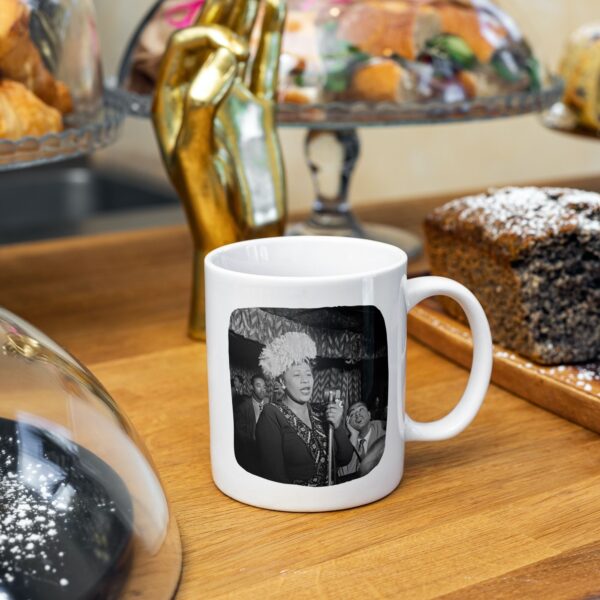 Mug with vintage photo of Ella Fitzgerald among pastries and decor.