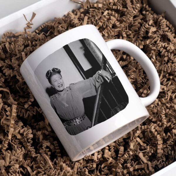 White mug with Ella Fitzgerald photo on shredded paper.