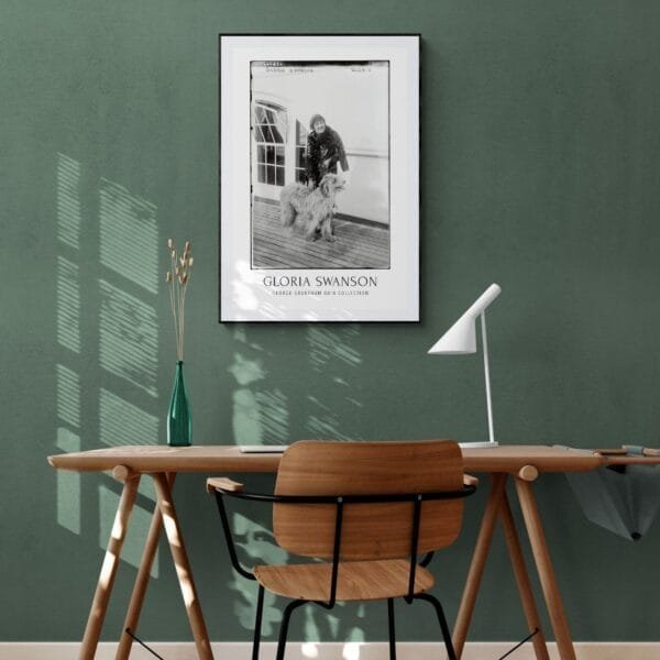 Vintage black-and-white Gloria Swanson poster featuring the Hollywood silent film star with a fluffy dog on a ship deck. Classic cinema-inspired wall art, available as a premium museum-quality print or foam board for retro decor lovers and old Hollywood enthusiasts.