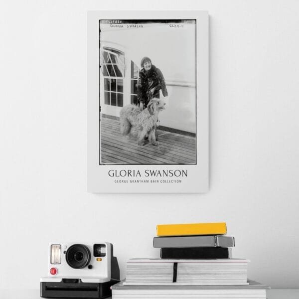 Vintage black-and-white Gloria Swanson poster featuring the Hollywood silent film star with a fluffy dog on a ship deck. Classic cinema-inspired wall art, available as a premium museum-quality print or foam board for retro decor lovers and old Hollywood enthusiasts.