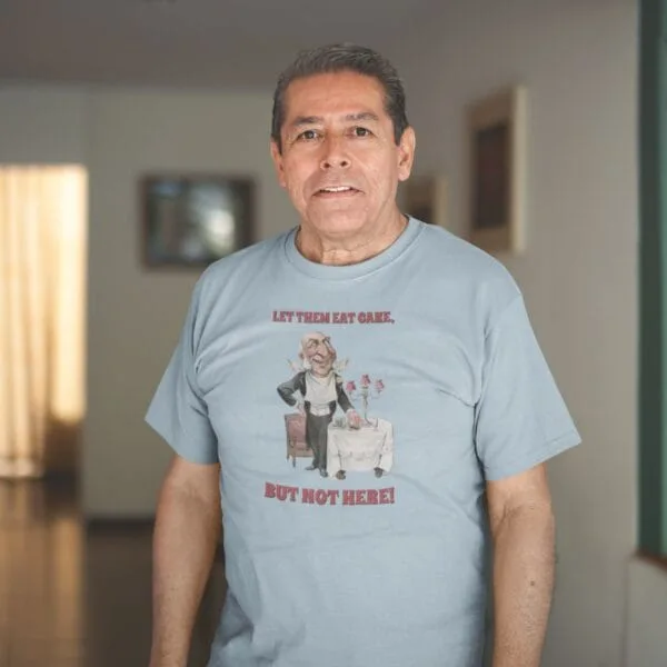 Vintage political satire T-shirt featuring bold caricature art with humorous social commentary. Retro graphic tee with witty statement, perfect for history buffs, political humor fans, and lovers of classic vintage illustrations. Unique gift idea.