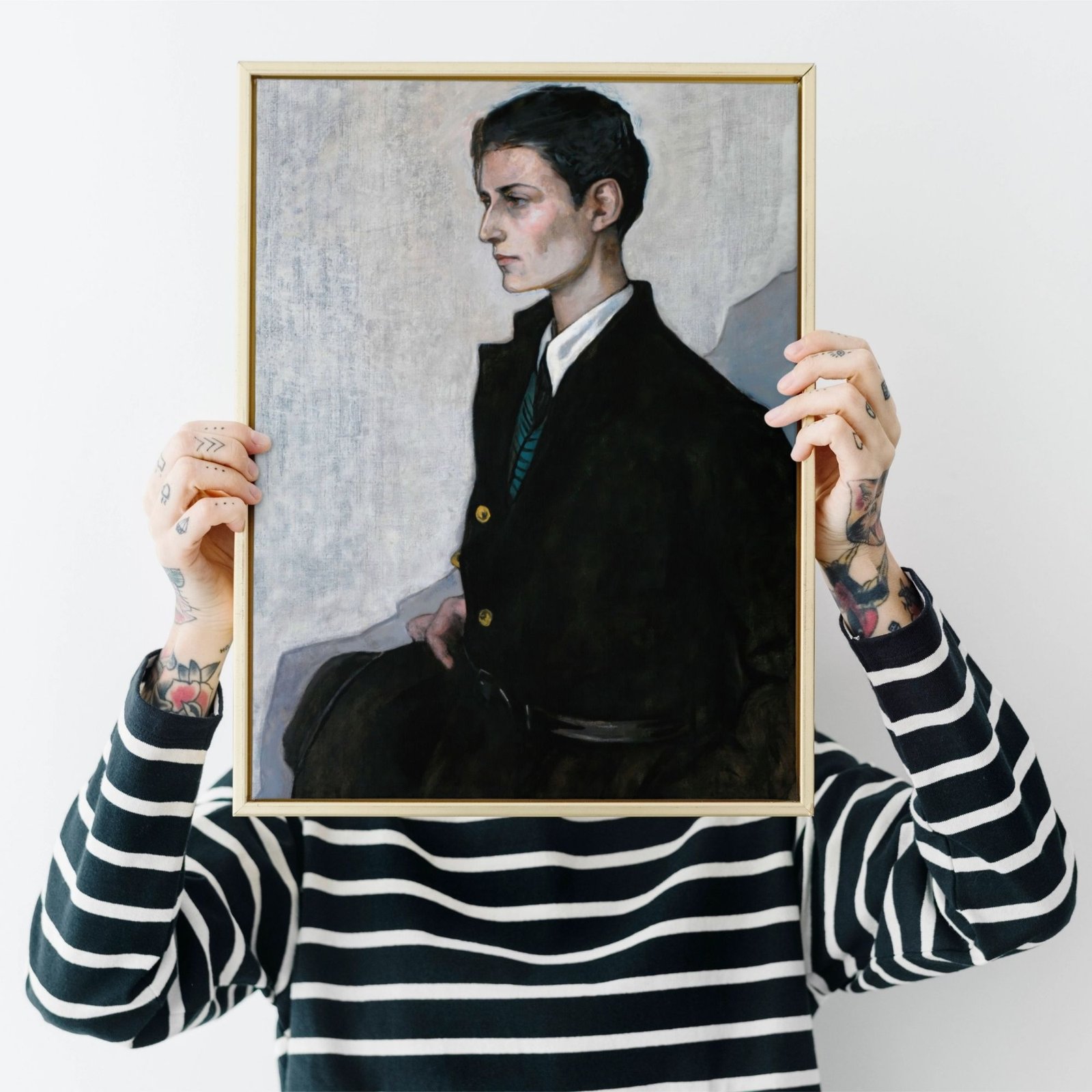 Person holding framed portrait over face.