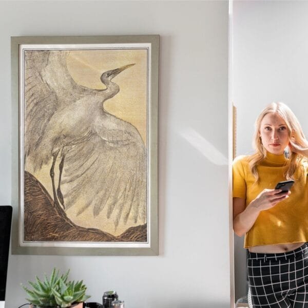 Art Nouveau print of a silver heron by Theo van Hoytema, framed and displayed in various interior settings. The detailed vintage-style illustration features a heron with outstretched wings, evoking elegance and nature-inspired beauty in home decor.