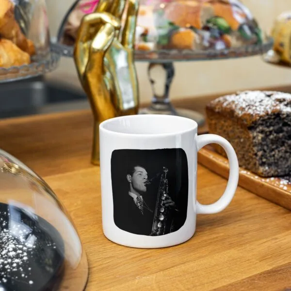 Coffee mug with saxophonist Tex Beneke, on wooden table.