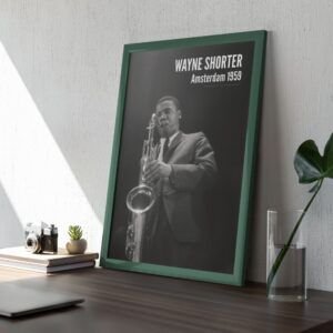 Framed photo of saxophonist on a desk.