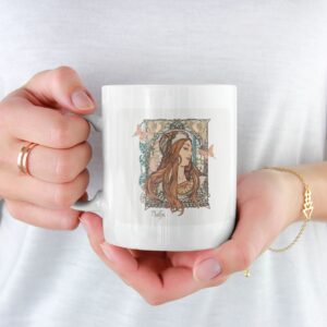 Woman holding mug with decorative art print