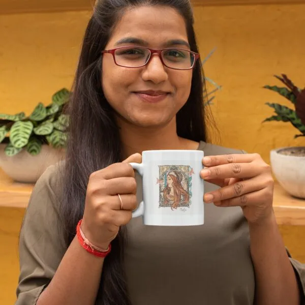 Smiling woman holding a decorative coffee mug.
