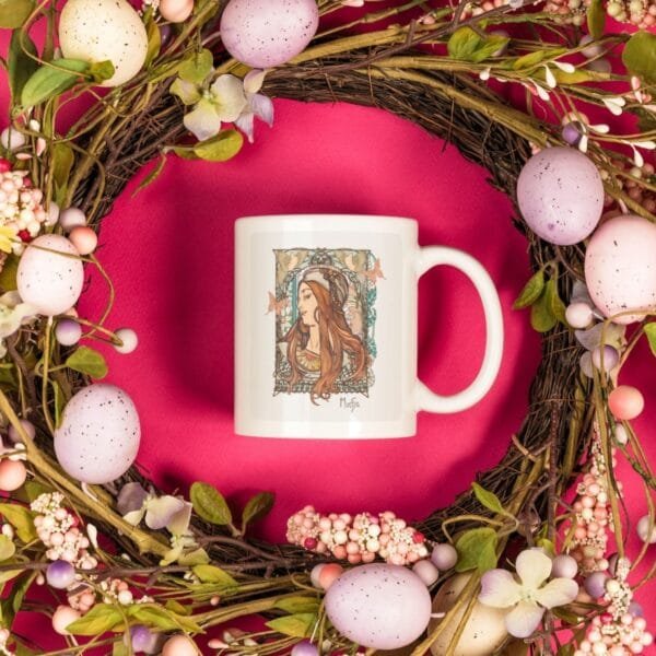 Decorative mug with floral wreath and eggs.