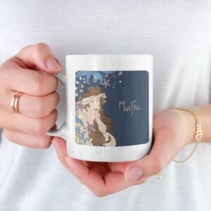 Person holding mug with Mucha art design.